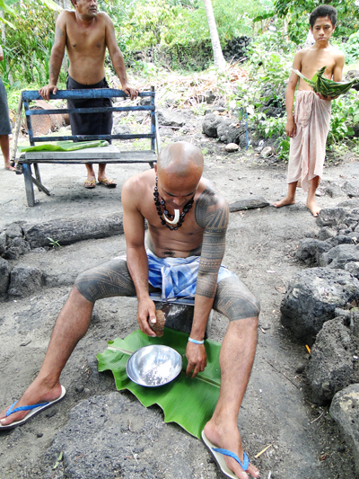 Grating fresh coconut on Manono Island