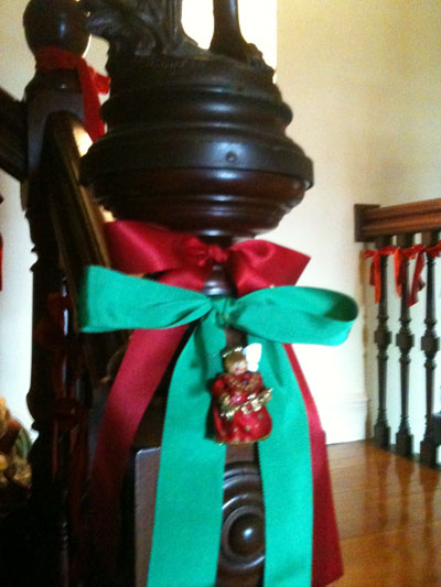 Red and green bows tied onto bannisters