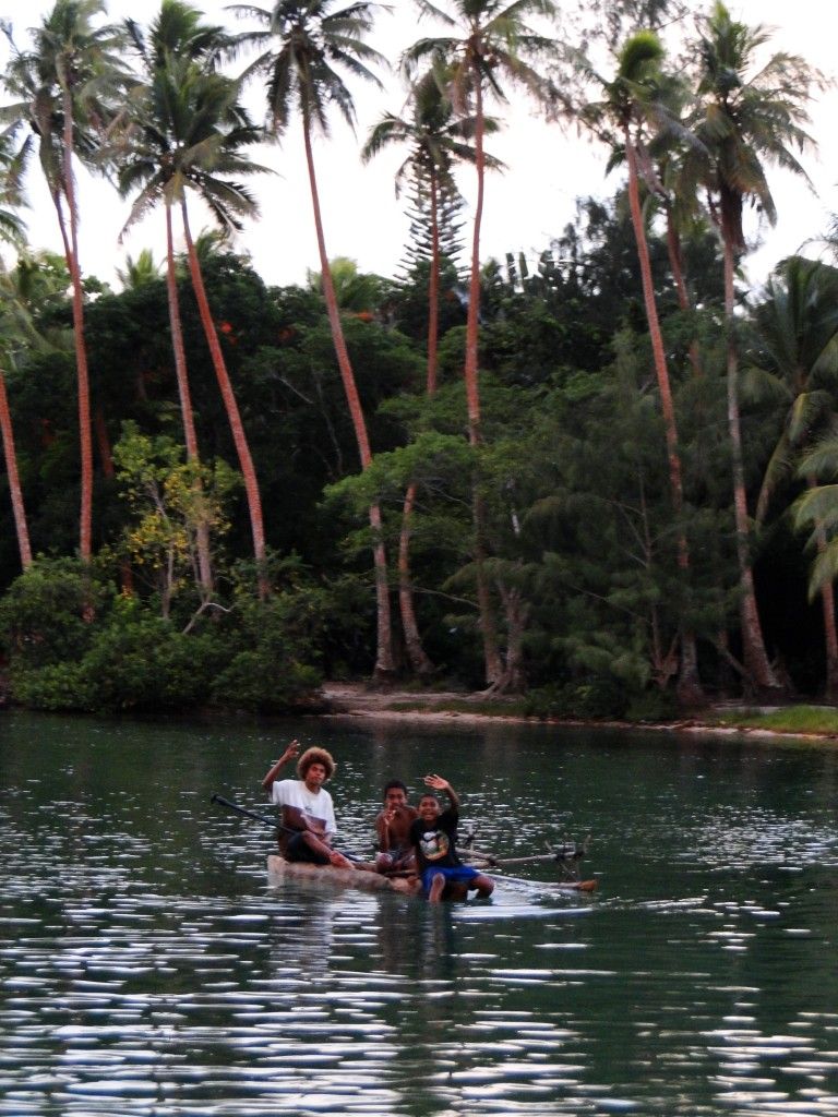 Local children sailing a pirogue on the second lagoon, Port Vila