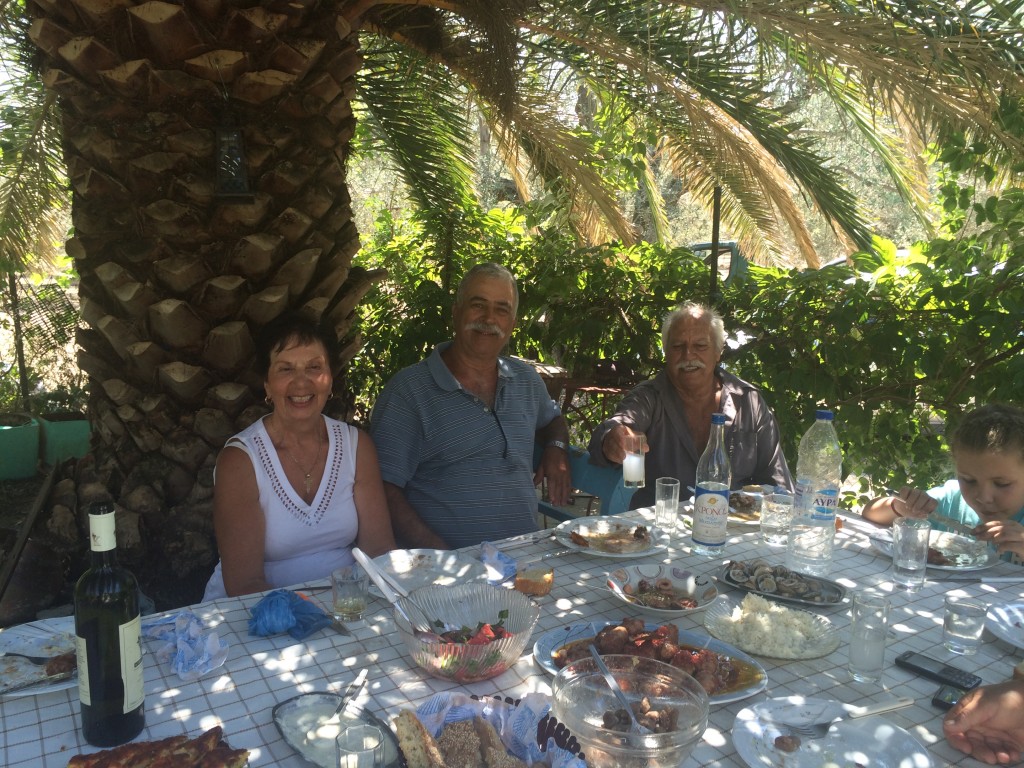 A traditional Greek family lunch under the palm tree, near the Gulf of Kalloni