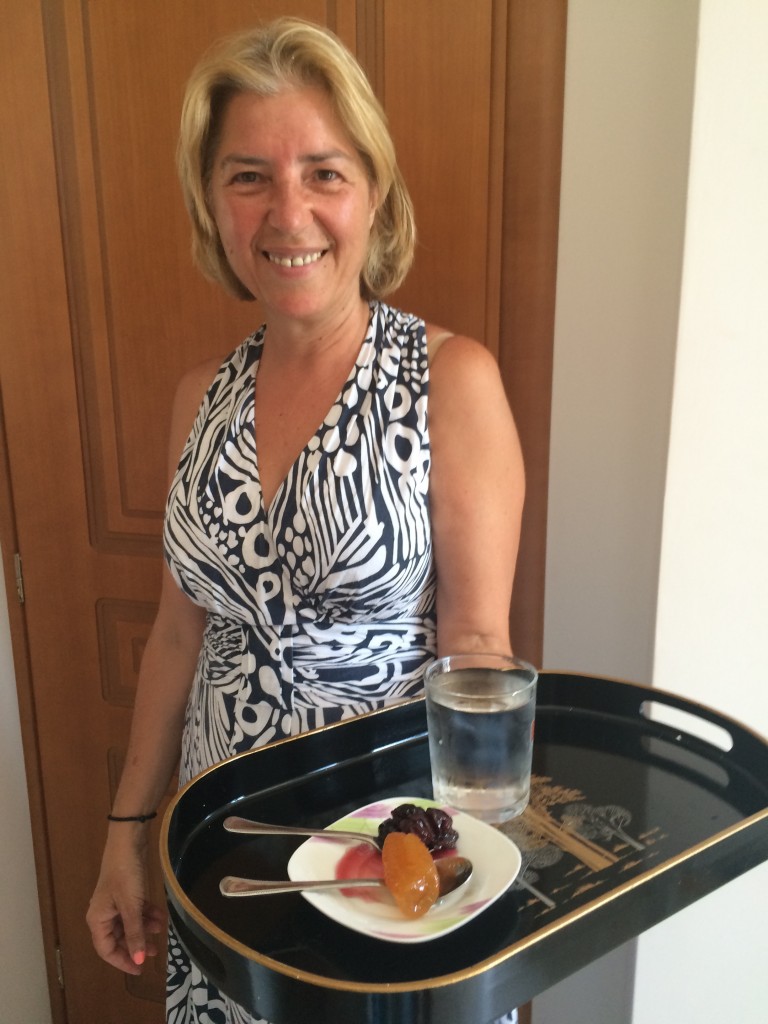 Evi Mitchell welcoming to her home in Agia Paraskevi with traditional cherry and rolled clementine spoon sweets